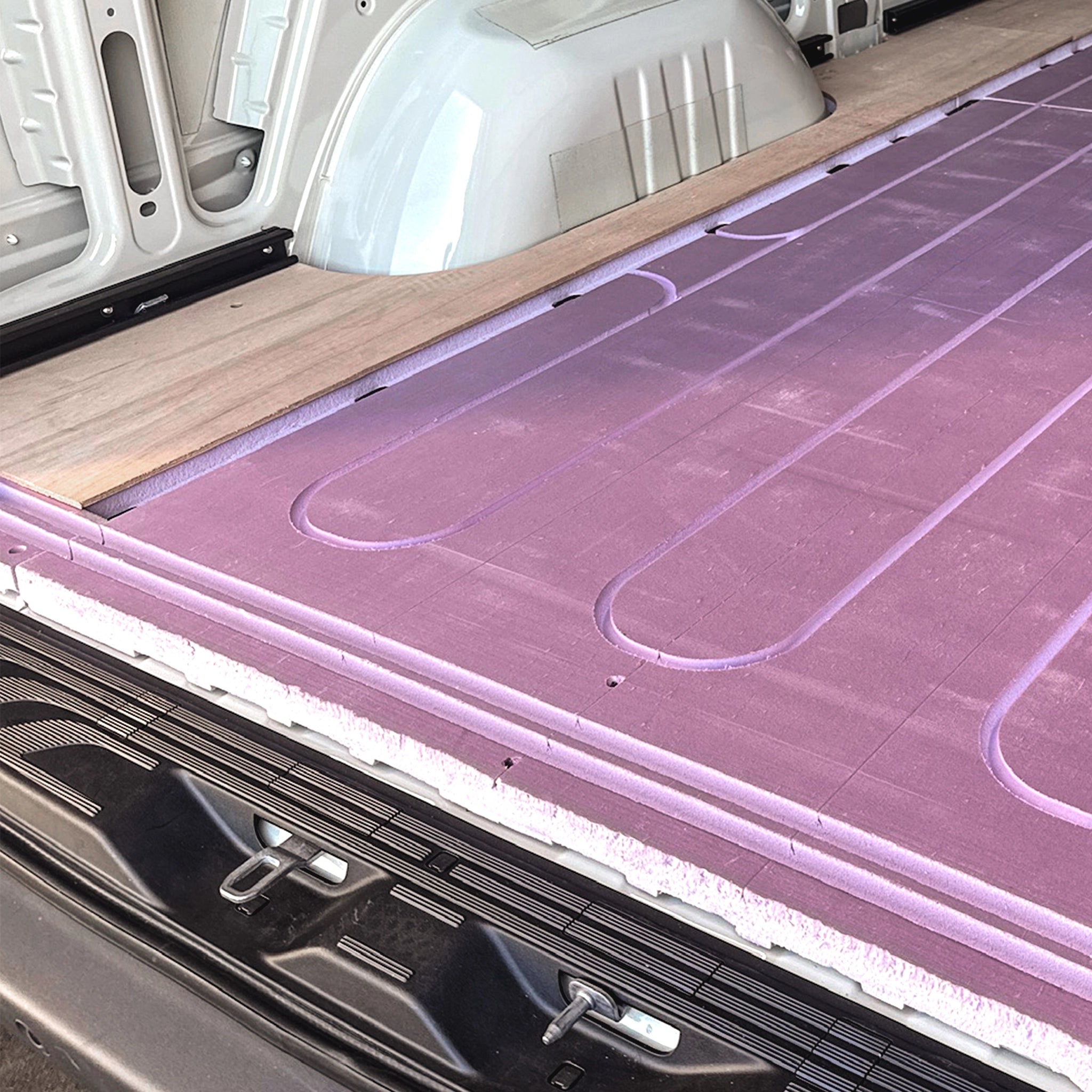 Insulated marine-grade plywood flooring installed in Sprinter van — Virtus Vans Base Camp kit